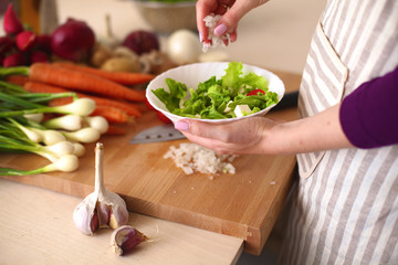 Young Woman Cooking in the kitchen. Healthy Food