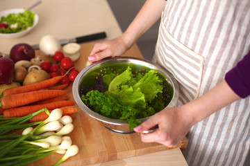 Young Woman Cooking in the kitchen. Healthy Food