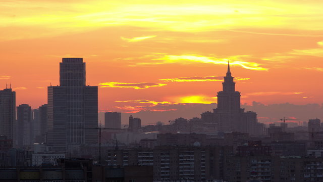 Moscow. Stalin skyscraper on the background of a large the sunset sun timelapse, Russia
