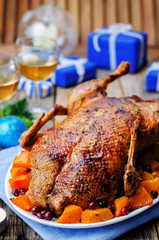 Duck baked with apples, pumpkin and cranberries