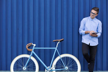 Businessman with bicycle and tablet