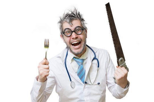 Funny and crazy doctor is laughing and holds saw in hand on whit