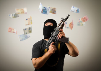 Man with gun and euro banknotes.