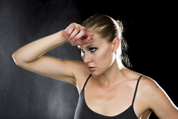 Thoughtful Athletic Woman with Hand on Forehead
