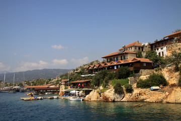 KEMER, TURKEY - AUGUST 09, 2010: Turkish village on the rocks at Mediterranean sea shore