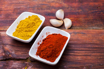 Spices powder on wooden board, close-up. Spices on table  