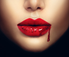 Sexy vampire woman lips with dripping blood