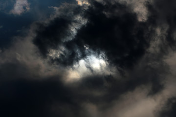 Obraz premium Sun screened by dark clouds