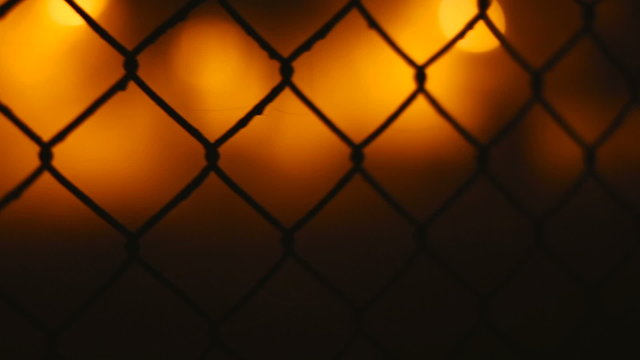 Fence wire mesh at night.