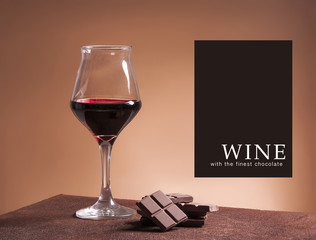 Red wine glass with the finest chocolate - obrazy, fototapety, plakaty