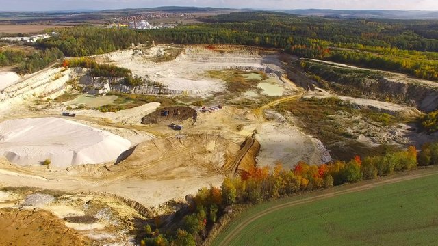 Camera flight over industrial zone Chlumcany kaolin quarry and ceramics factory near Pilsen in Czech Republic.