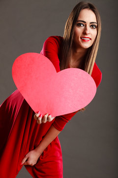 Girl holding red heart love sign