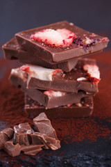 Stack of chocolate slices strawberry on a dark background.