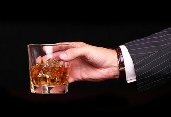 rich and success business man holding in hand glass of alcohol s