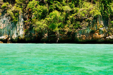 Green sea water infront of green island