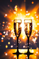 champagne glass against sparkler background