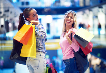 happy young girls in  shopping mall