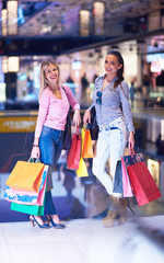 happy young girls in  shopping mall