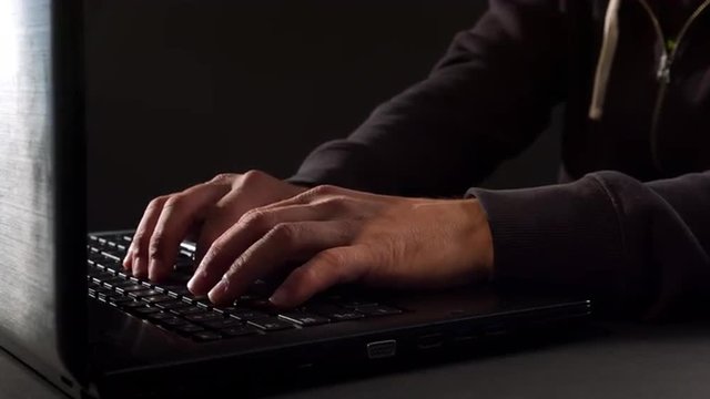 Man's hands typing on keyboard 4K