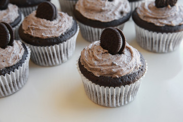 Homemade dark chocolate cupcakes with cookie and cream frosting