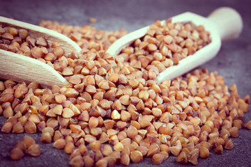 Vintage photo, Buckwheat groats with spoon on cement structure