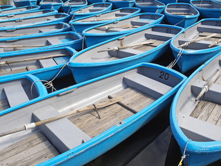 Fototapeta na wymiar group of blue rowboat at river