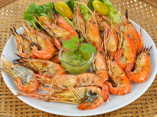 Delicious grilled shrimps with dipping sauce in the dish