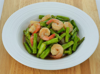Thai food , Asparagus stir fried with prawns on wooden floor