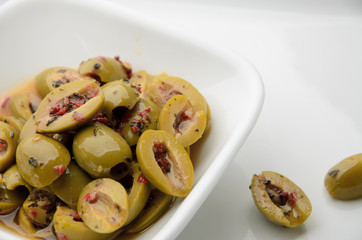 Split olives in white bowl