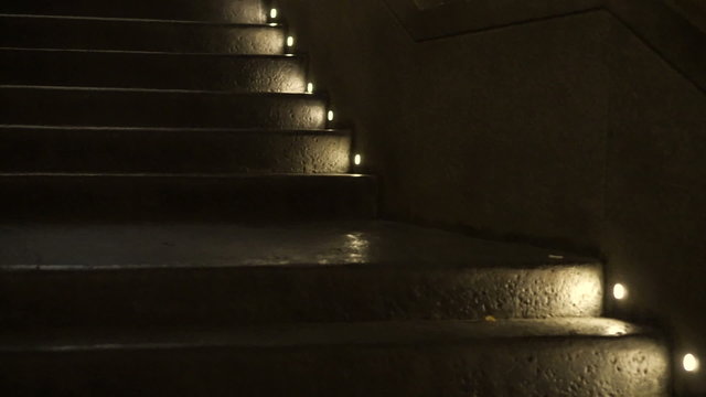 step light at night lit on raw concrete texture