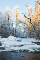 Ice floes and snow in the river in the winter forest