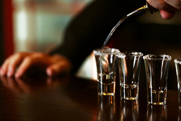 Bartender is pouring tequila into glass