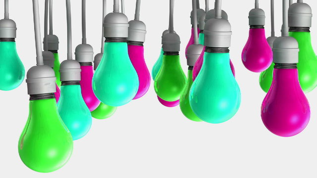 A pan across a group of regular hanging multicolored and changing light bulbs attached to cables on an isolated white background