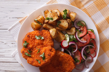 German Weiner schnitzel with potatoes closeup. horizontal top view
