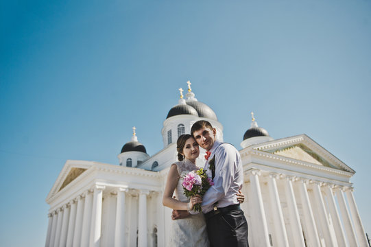 Husband and wife hugging on the background of the Church 3796.