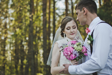 The tender embrace of the newlyweds in the woods 3948.