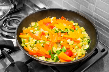 cooking colorful sliced vegetables pan - vegan recipes