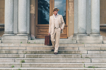 Vintage commercial traveler walking down stairs at front door.