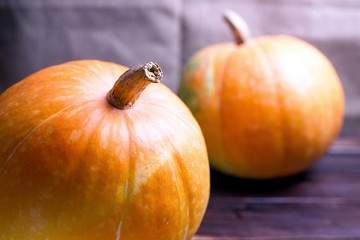 Two big pumpkins on a table