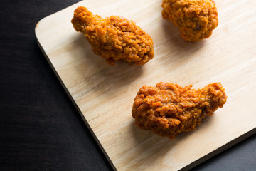 Chicken coated with flour and spices fry until crispy placed on
