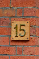 House number 15 sign on wall