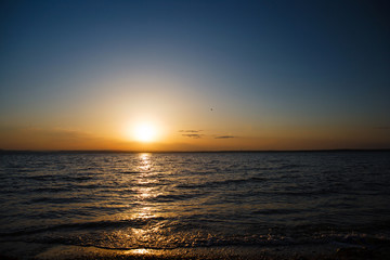 Sunset over the sea, a beautiful evening ocean, water nature, wildlife of the sea, the horizon, a romantic trip, beach night, sea waves, coastal landscape, views of the sun.