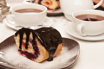 On the white tablecloth is a samovar, a teapot, a cup of tea and sweets, biscuits, rolls, tea,