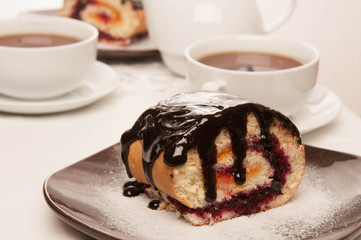 On the white tablecloth is a samovar, a teapot, a cup of tea and sweets, biscuits, rolls, tea,