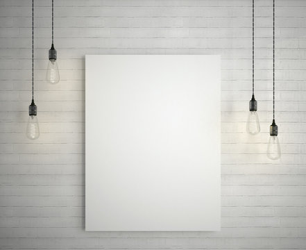 Blank white poster on brick wall hanging under decorative vintage light bulbs