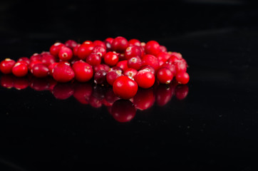 frozen cranberries on a black background