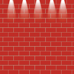 Fototapeta premium Red brick wall is illuminated by the rays of light