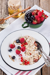  Granola, muesli , honey, yogurt and fresh berries .Healthy breakfast.selective focus
