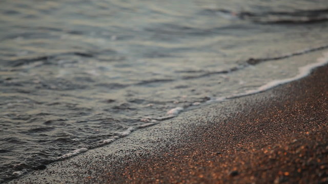 Fabulously shaped wave breaking on a beach at sunrise