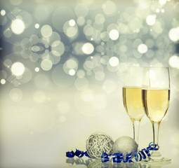 Holiday background with sparkling lights and champagne